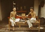 Bac Ky, Hanoi 1915 - Two Vietnamese people drink tea and smoke pipe tobacco in an opium smokin...jpg